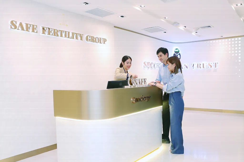 Couple checking in at the SAFE Fertility Group reception counter